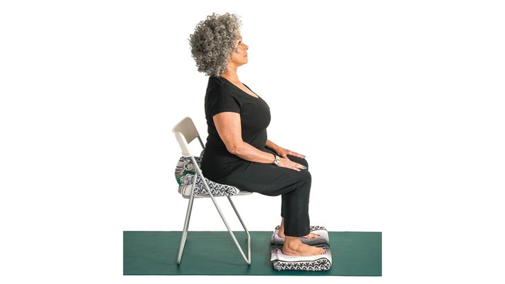 Woman sitting upright in a chair