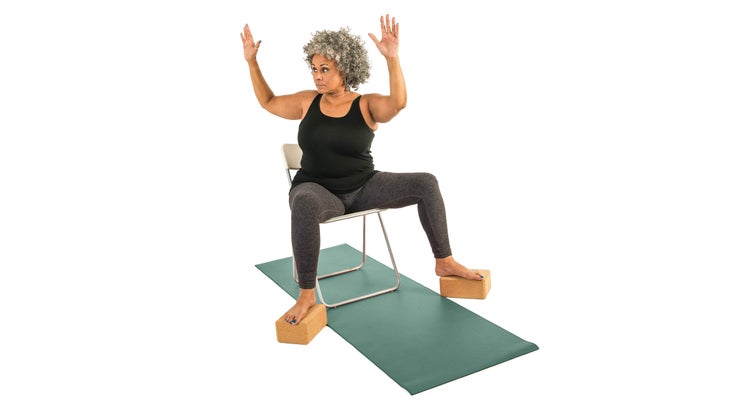 Woman performing a goddess twist in a chair