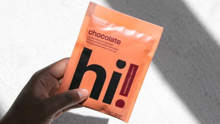 Hand holding packet of Hi protein powder