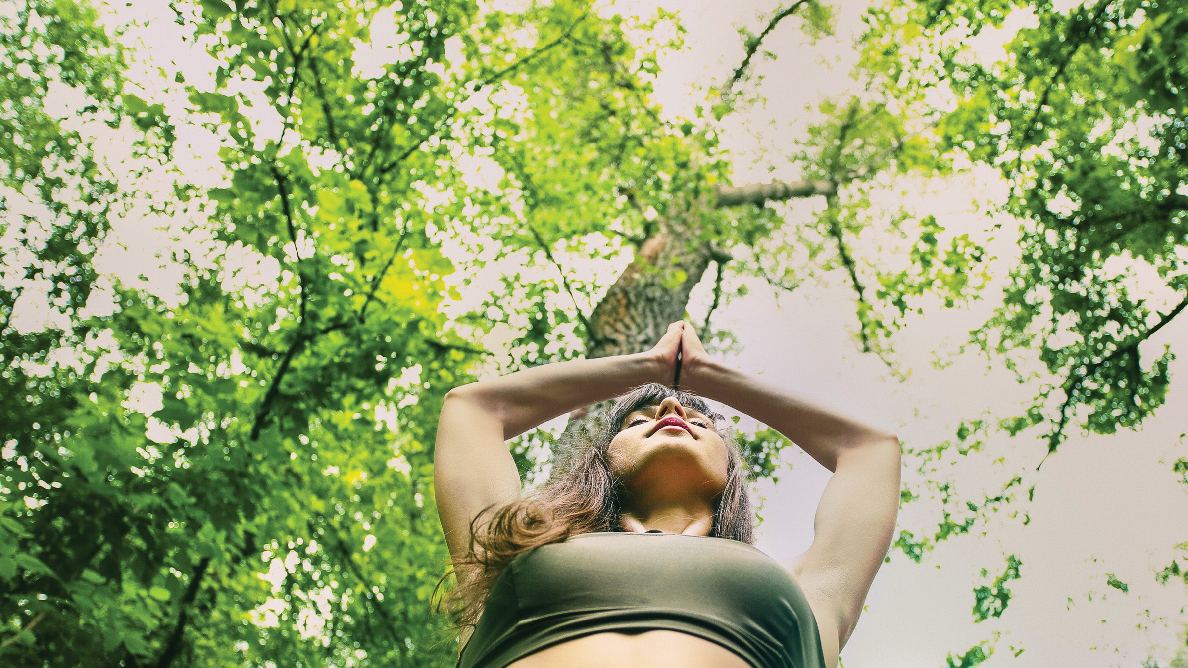 Woman meditating in the forest