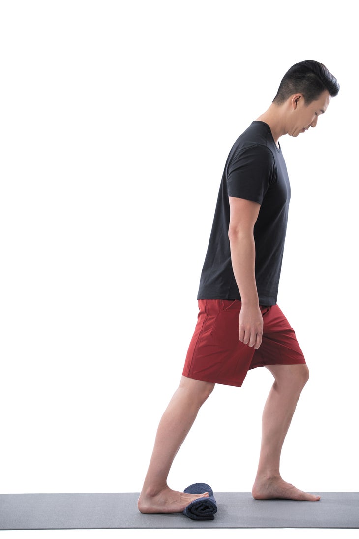 A man performs a foot stepover