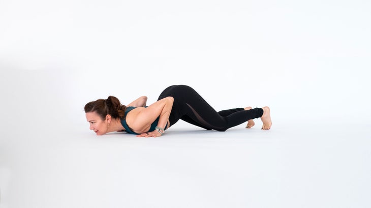 Dana Slamp demonstrates knees chest chin in yoga