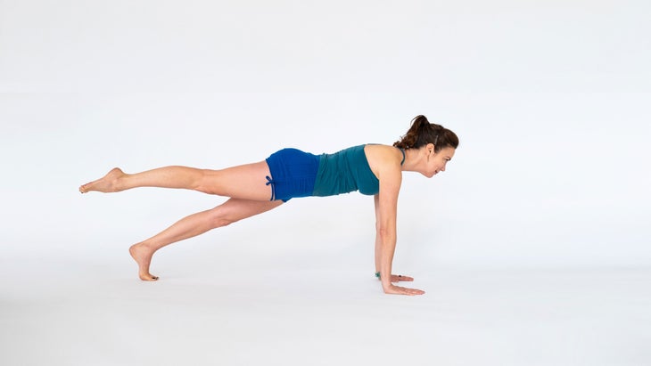 A woman demonstrates a Plank Pose variation