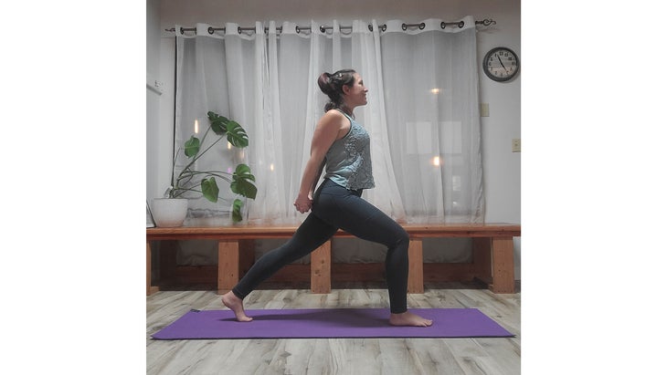 A person performs High Lunge variation in yoga