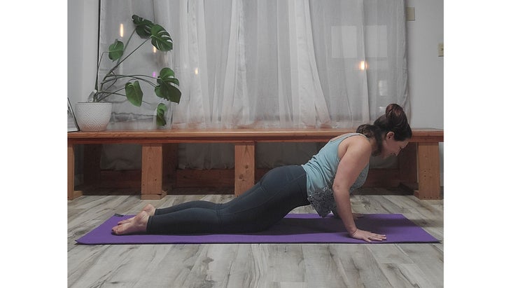 A person performs Chaturanga Dandasana, variation (Four-Limbed Staff Pose)