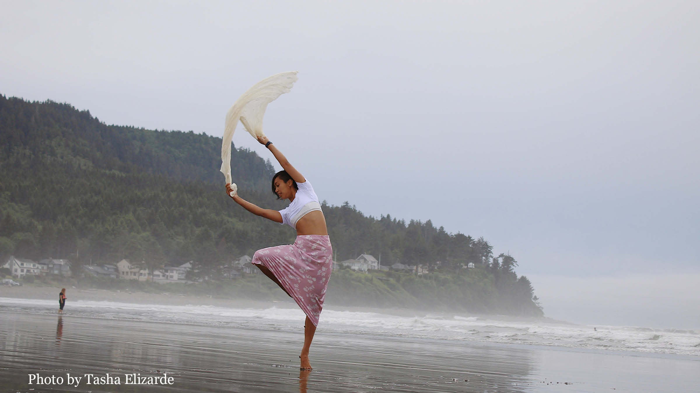 Trisha Fey Elizarde dancing with a scarf on a beach