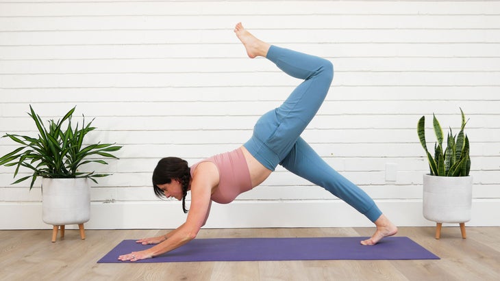 A woman demonstrates a variation of Downward-Facing Dog Pose in yoga