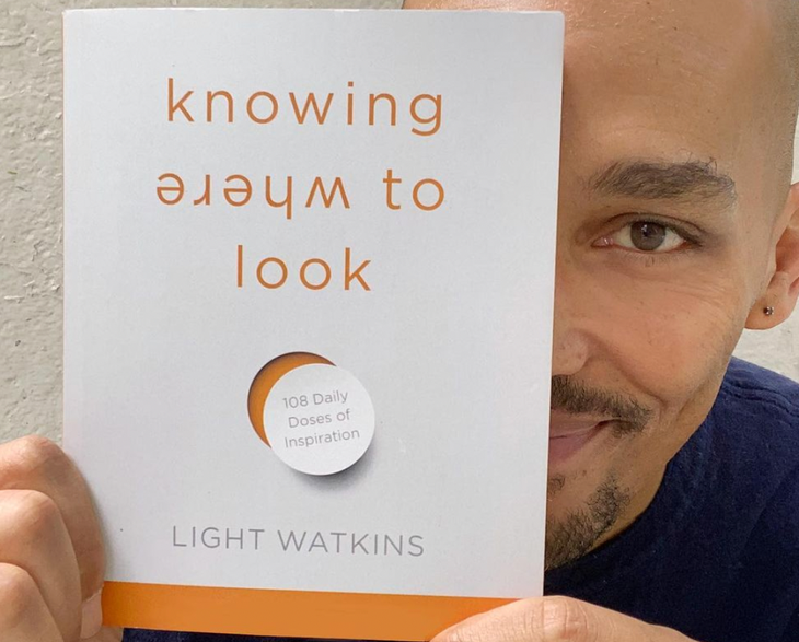 Light Watkins holds up his new book, Knowing Where to Look: 108 Doses of Inspiration