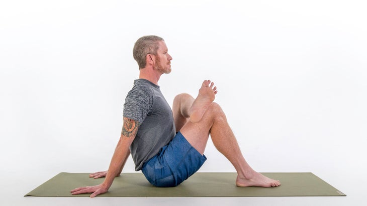 Man demonstrates modification for One-Legged King Pigeon Pose I