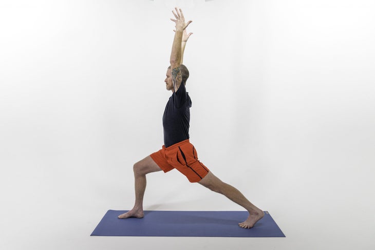 White man in red shorts in a High Lunge