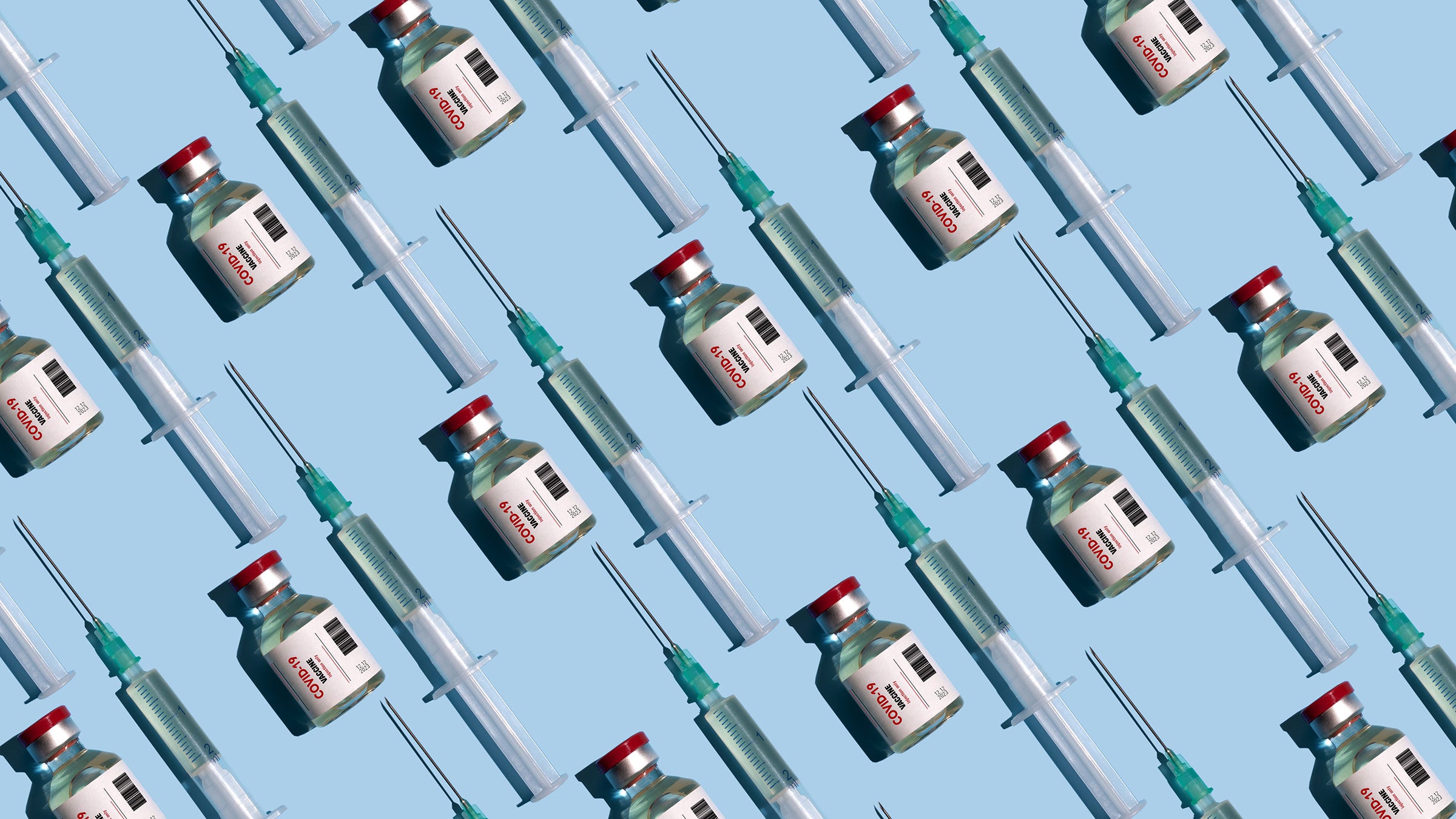 Vials of vaccinations labeled COVID-19 appear on a light blue background