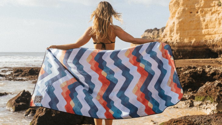 Woman holding up a striped towel