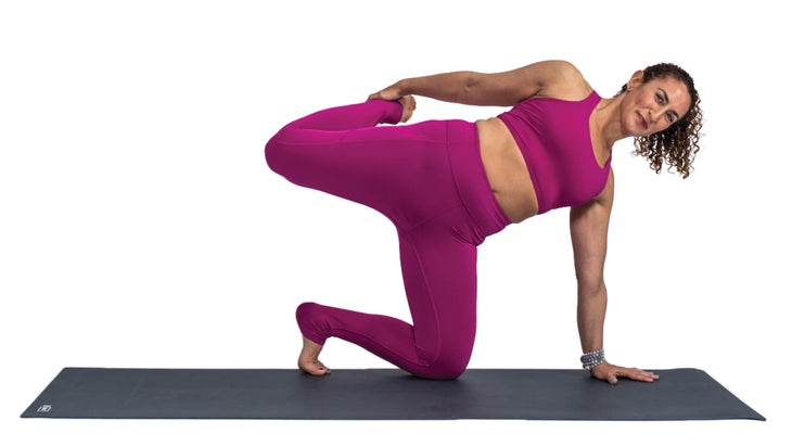 Woman in a side plank pose variation