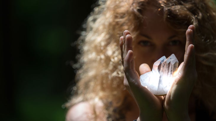 A woman holds clear quartz