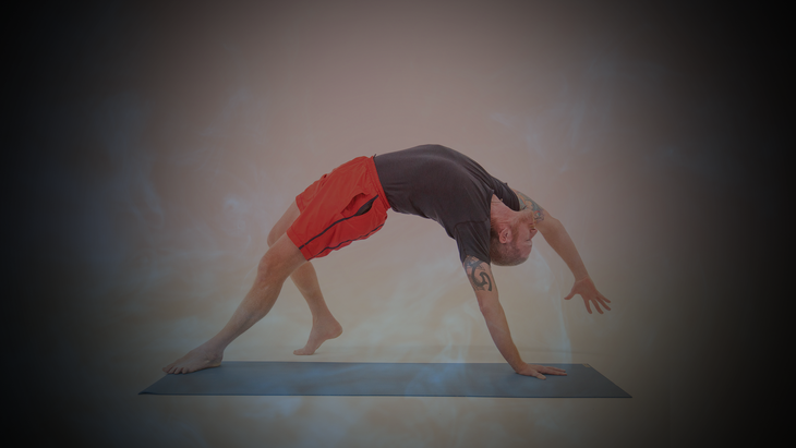 A man in red shorts bend back into Wild Thing pose