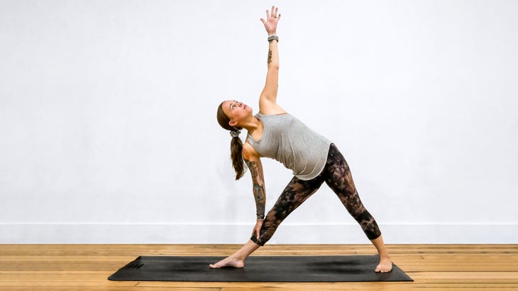 A woman demonstrates Extended Triangle Pose in yoga
