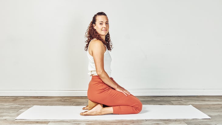 Woman in supported Hero Pose