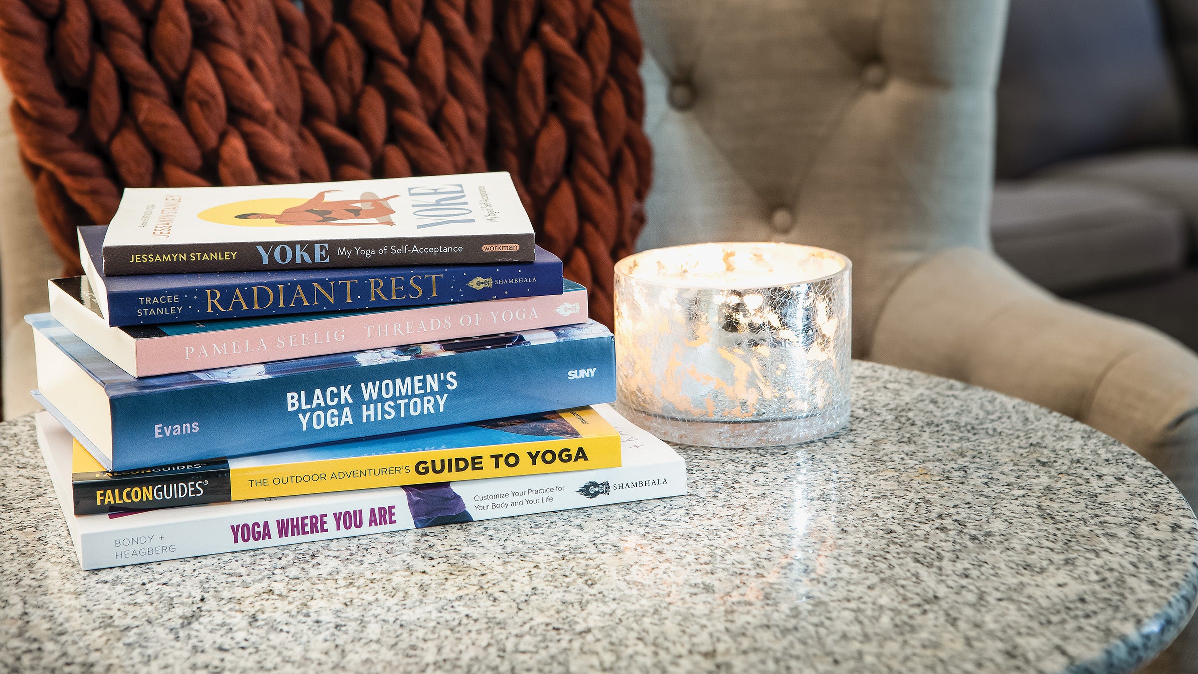 Stack of yoga books on a side table