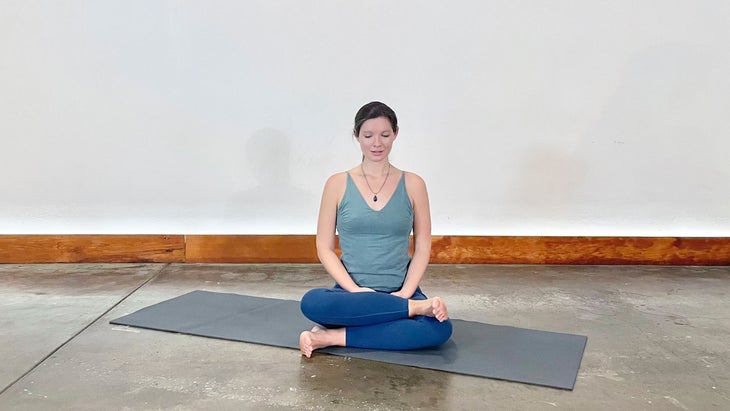 A person demonstrates Fire Log Pose in yoga