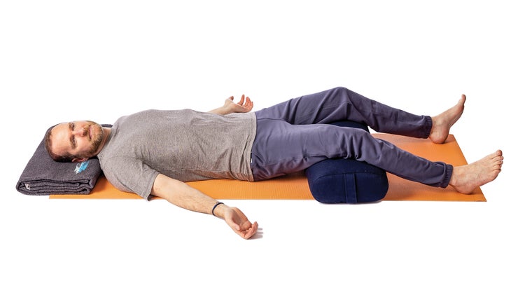 Jivana Heyman performing supine neck rolls