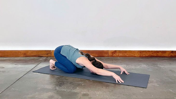 A person demonstrates Pranam Bowing in yoga