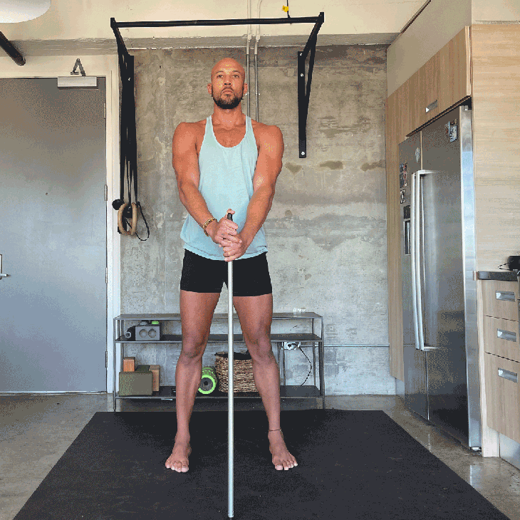 Rocky Heron diagonal squats with dowel
