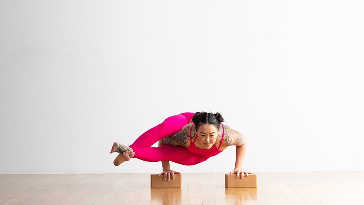 Woman in Eight-Angle Pose modification with blocks