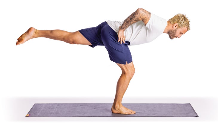 Calvin Corzine in a bent-leg Warrior III pose