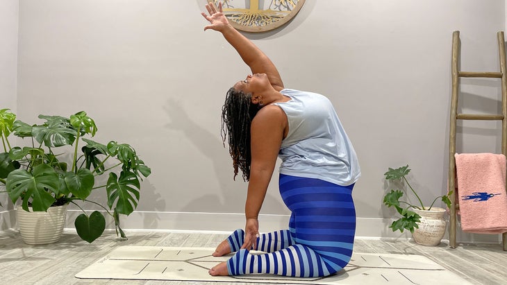 A person demonstrates Ardha Ustrasana (Half Camel) in yoga