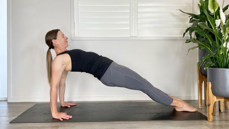 A person demonstrates a variation of Purvottanasana (Reverse Plank) in yoga