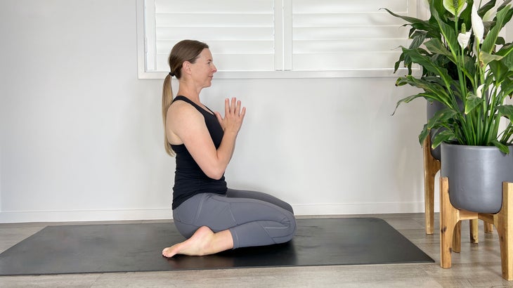 A person demonstrates Virasana (Hero Pose) in yoga