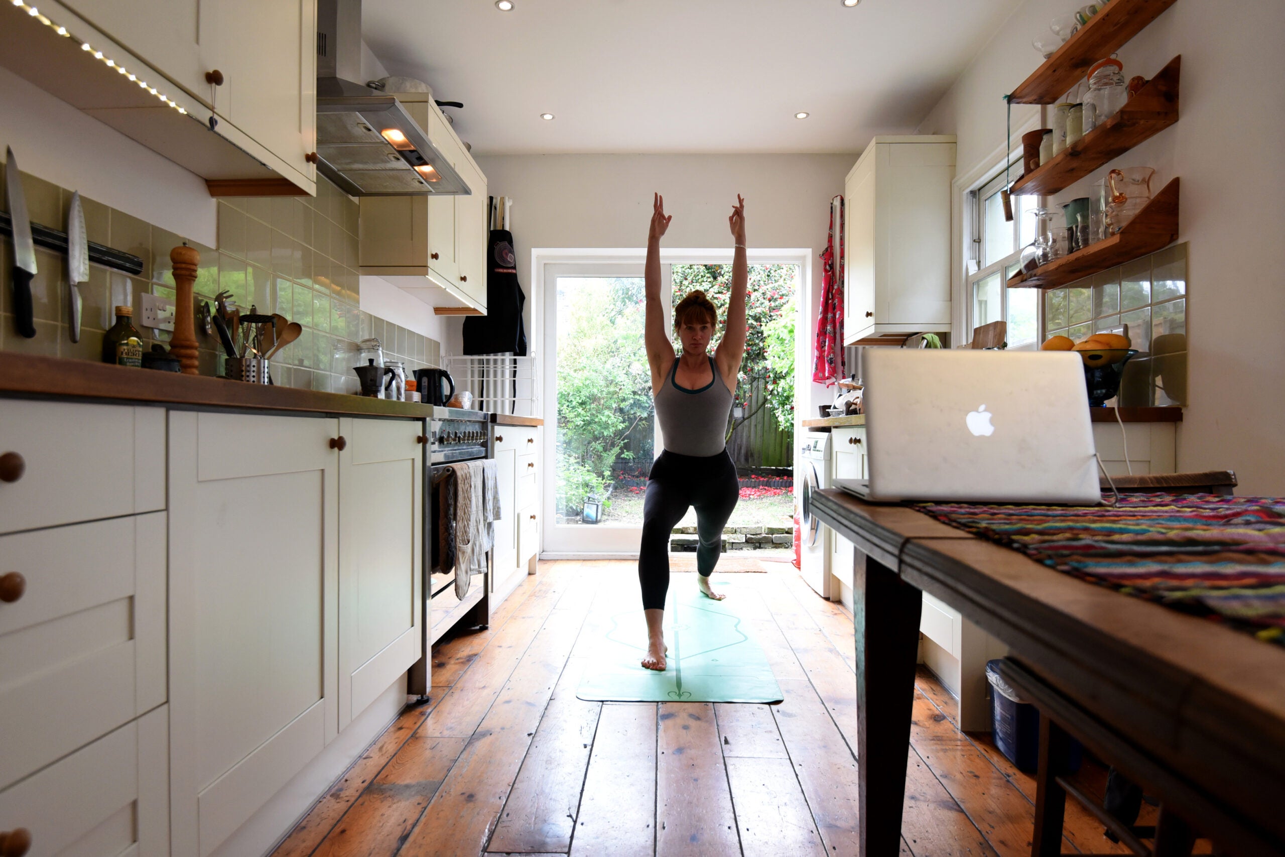 LONDON, ENGLAND - APRIL 30: Jessica the photographers housemate, takes part in an online yoga lesson in her kitchen on April 30, 2020 in London, England. (Photo by Kate Green/Getty Images)