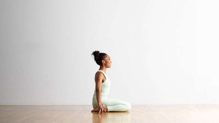 Woman demonstrates Hero Pose