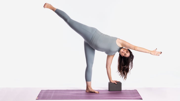 Sarah Ezrin in a supported half moon pose