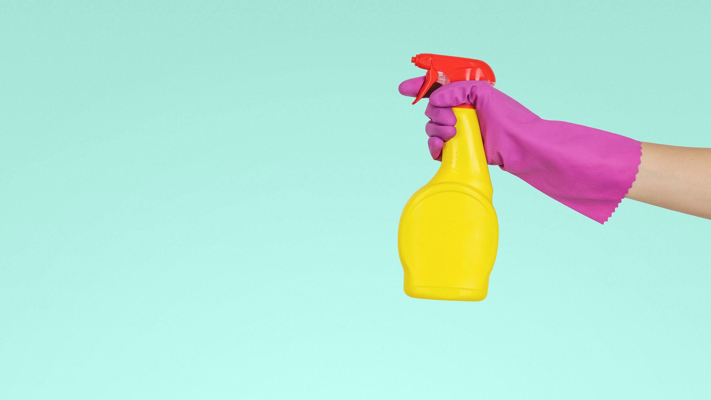 Person holds a yellow spray bottle