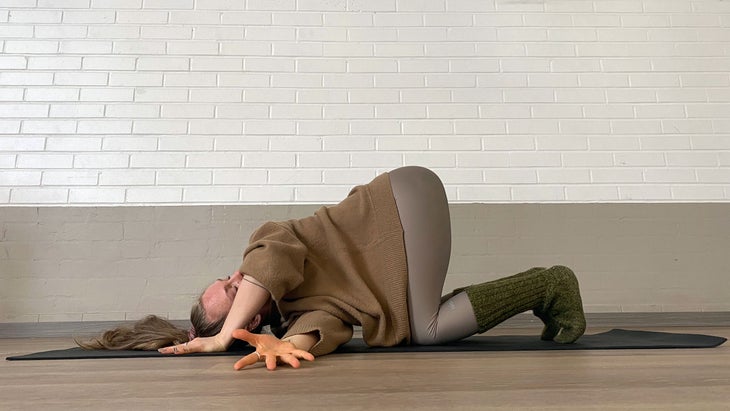 A person demonstrates Thread the Needle position in Yin Yoga
