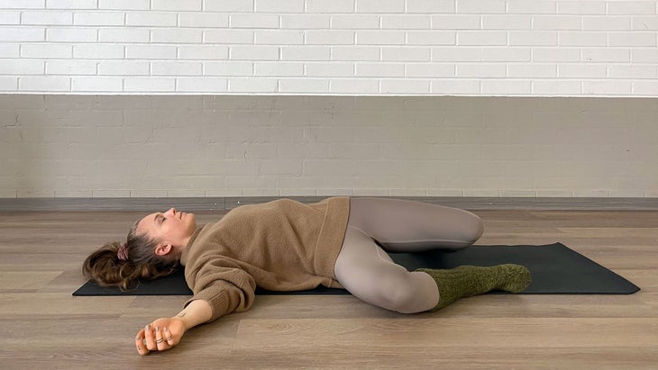A person demonstrates how to Windshield Wiper your knees in Yin Yoga