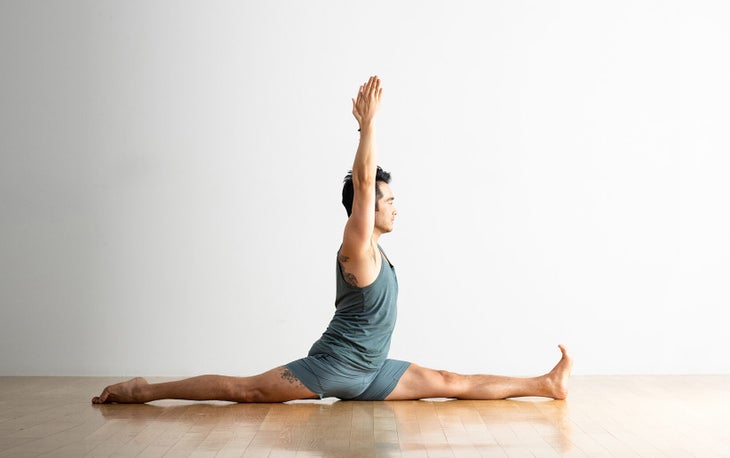 A person practices Hanumanasana, the Splits or Monkey Pose in yoga