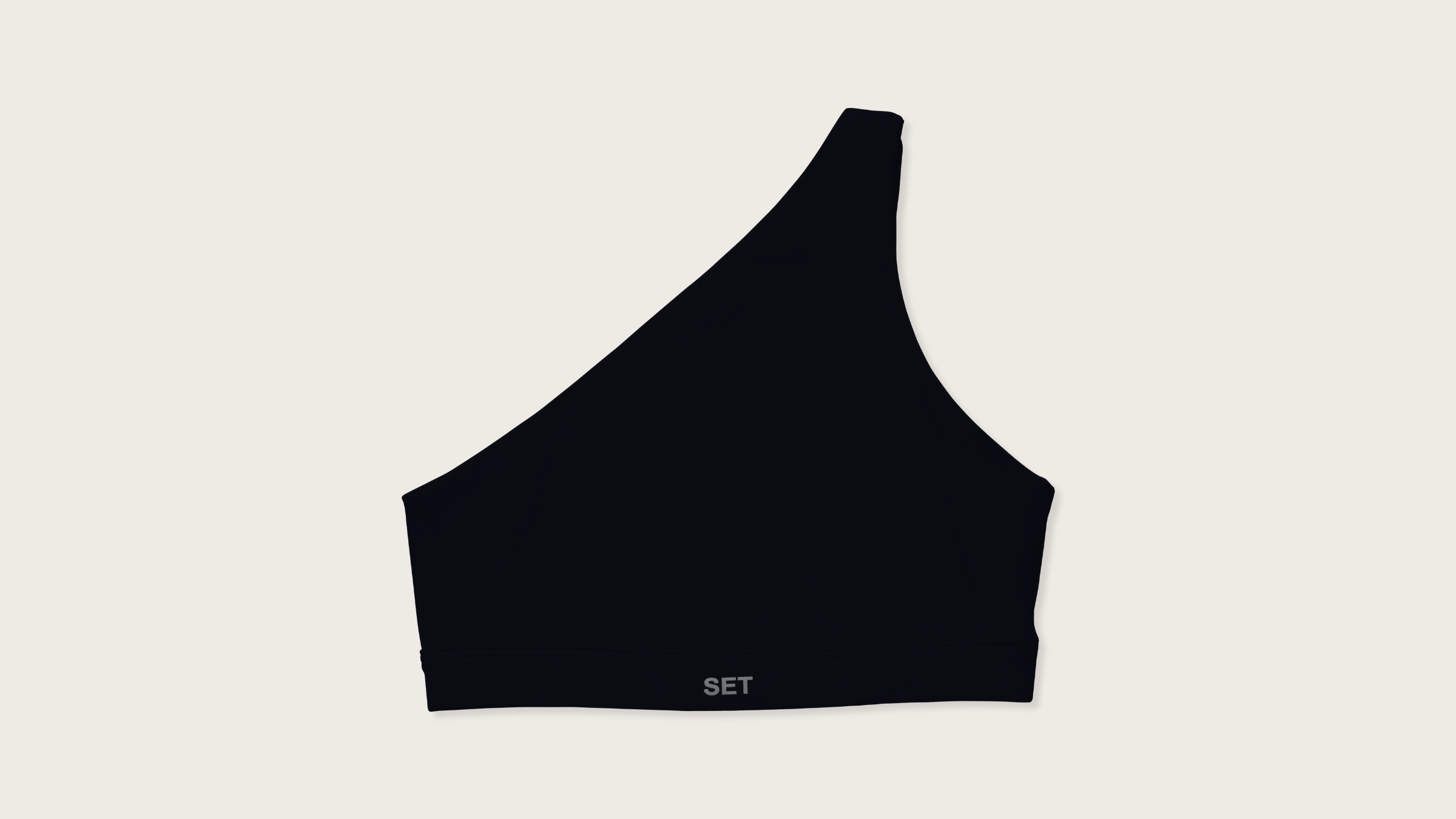 A black one-shoulder sports bra on a flat lay