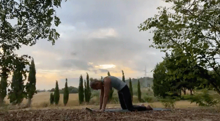 Woman practicing yoga outside in the early morning