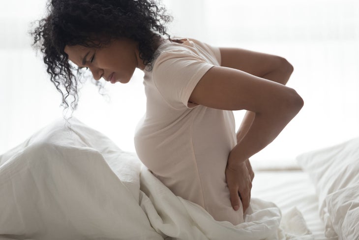 Woman doing stretches for low back pain relief