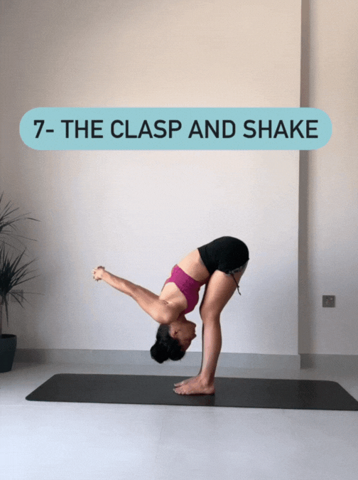 Woman standing on her yoga mat in Uttanasana with her hands clasped behind her back, bending and straightening her knees, swaying side to side
