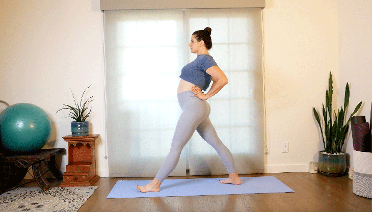 Woman with a shoulder injury on her yoga mat with her hands on her hips practicing a modification