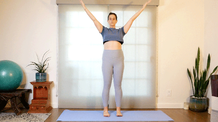 Woman with a shoulder injuring practicing yoga with a modification for a standing pose