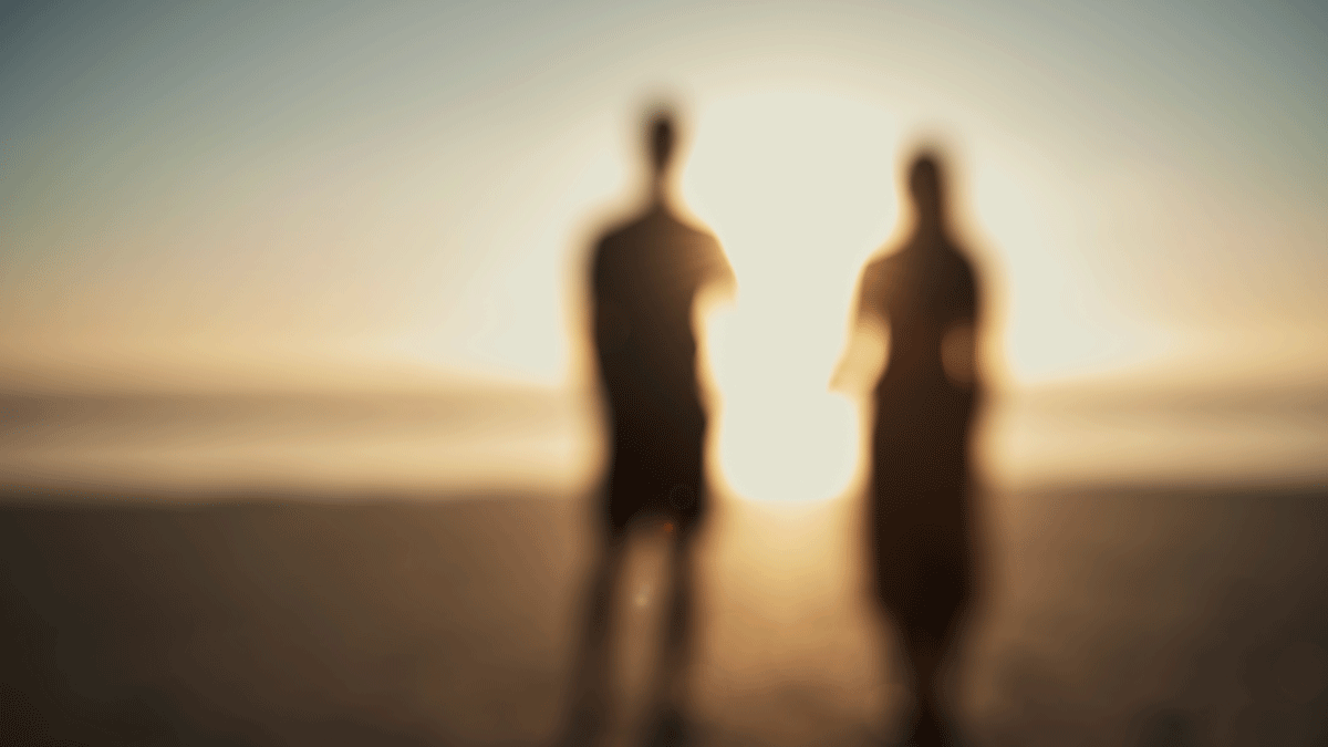 A couple standing together on the beach considering Mercury retrograde's effect