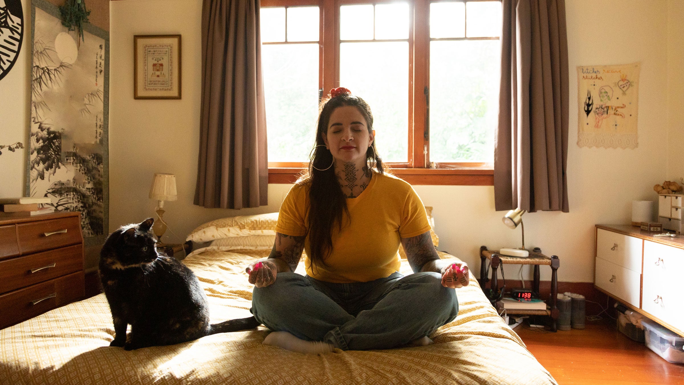 Woman meditates on her bed