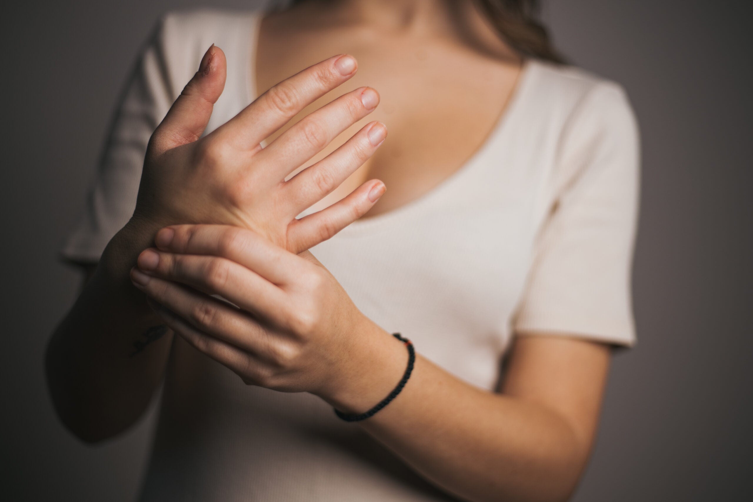 Close-up of woman massaging her wrist