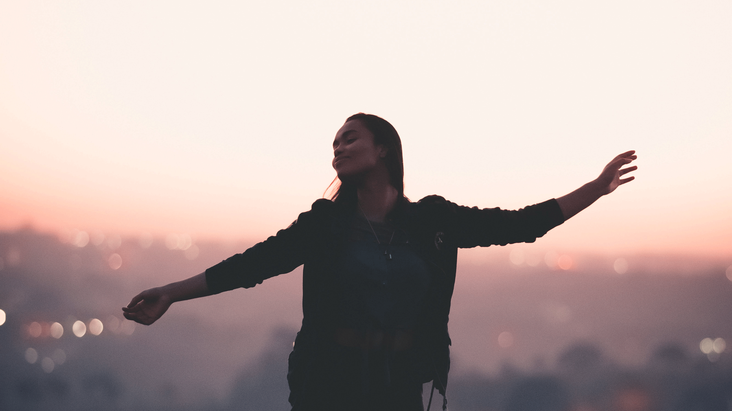 Woman outside at sunrise on a run while considering her weekly horoscope for May 11-17, 2025