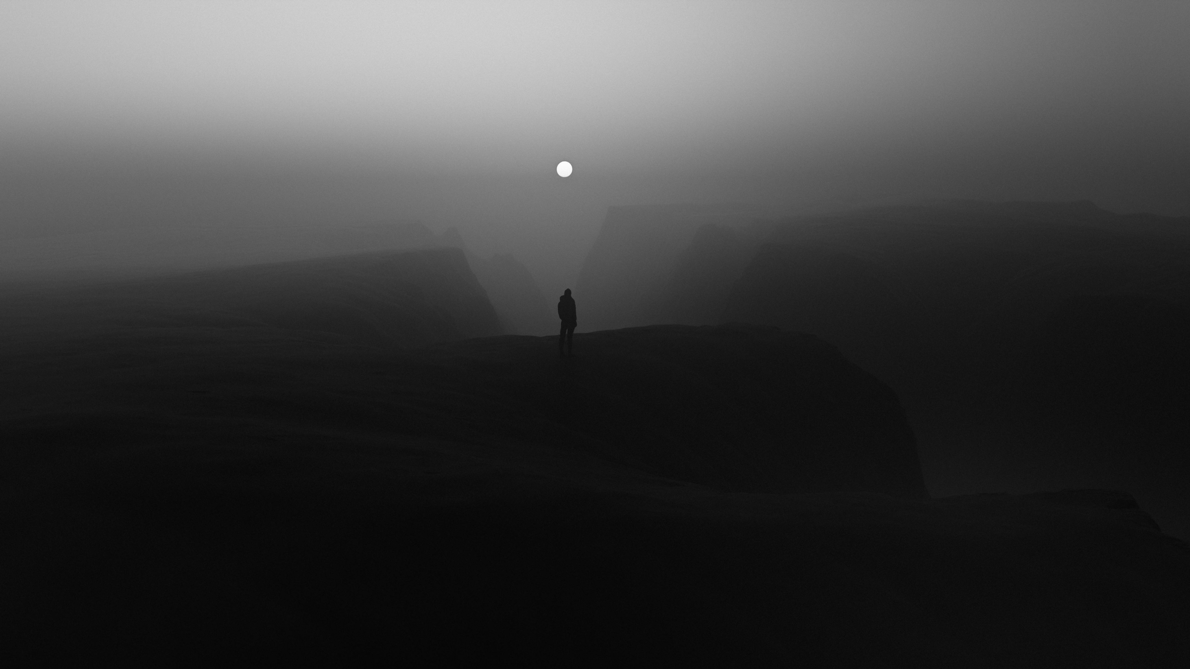 Woman standing on the beach beneath the full Moon in Scorpio