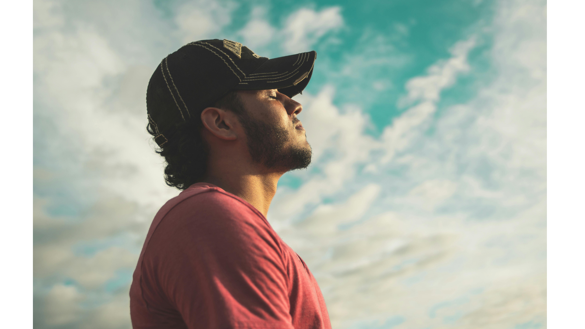 Man in a baseball cap meditating